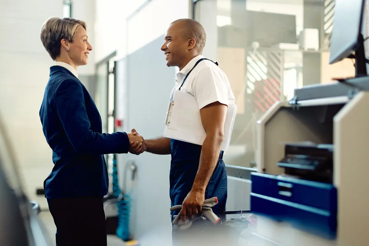 banner__0000s_0007_happy-businesswoman-handshaking-with-african-american-mechanic-auto-repair-shop